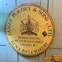 Vintage round wooden Purdey & Sons gun sign