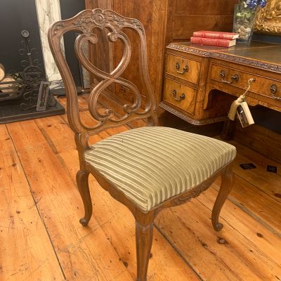 Antique wooden chair with fabric seat