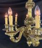 Decorative brass chandelier with cherub detailing 