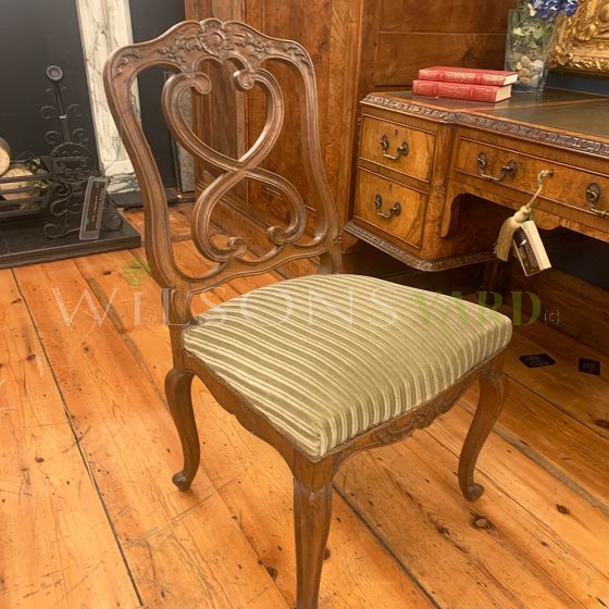 Antique wooden chair with fabric seat